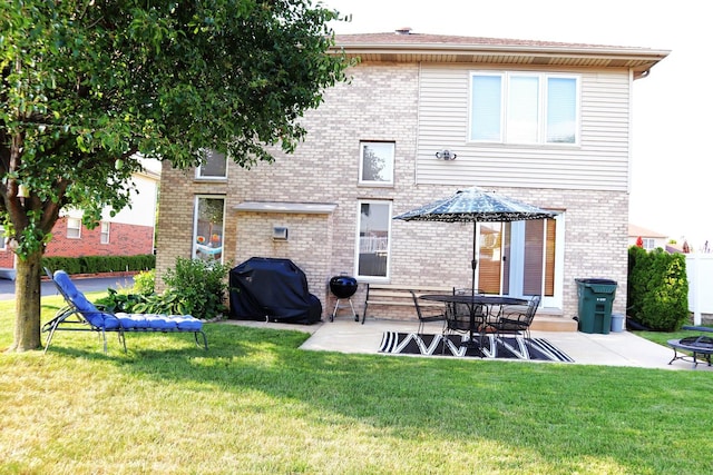 back of house with a patio area and a yard