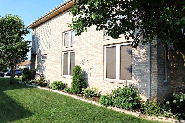 view of home's exterior with a yard