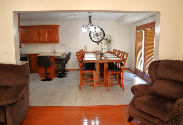 tiled dining area featuring a chandelier