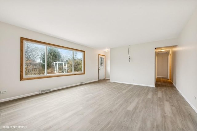 spare room featuring light wood-type flooring