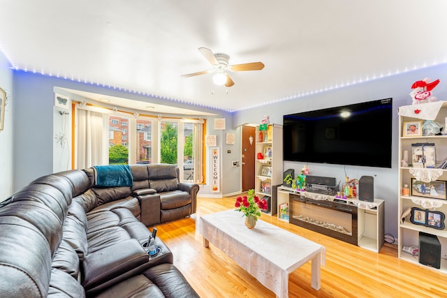 living room with ceiling fan and light hardwood / wood-style floors