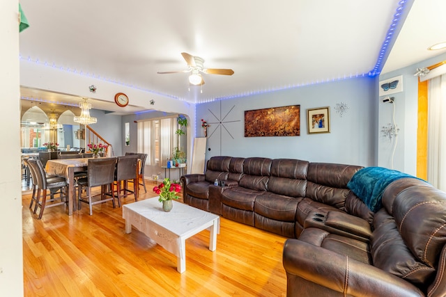 living room with ceiling fan and light hardwood / wood-style flooring