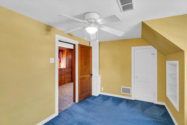 bonus room with ceiling fan and carpet flooring