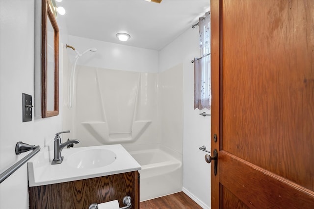 bathroom with vanity, hardwood / wood-style floors, and shower / bath combination