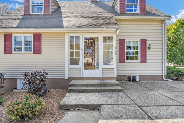 view of exterior entry featuring a patio