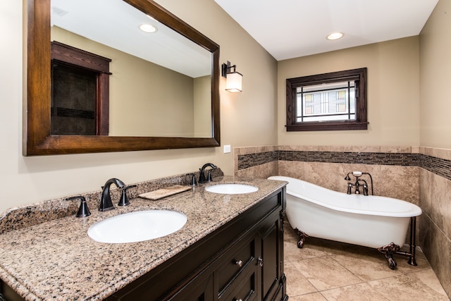 bathroom featuring double vanity, a washtub, and tile patterned floors