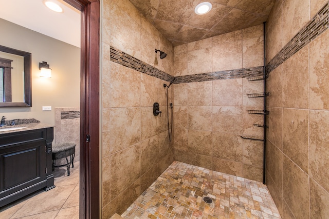 bathroom featuring vanity and a tile shower