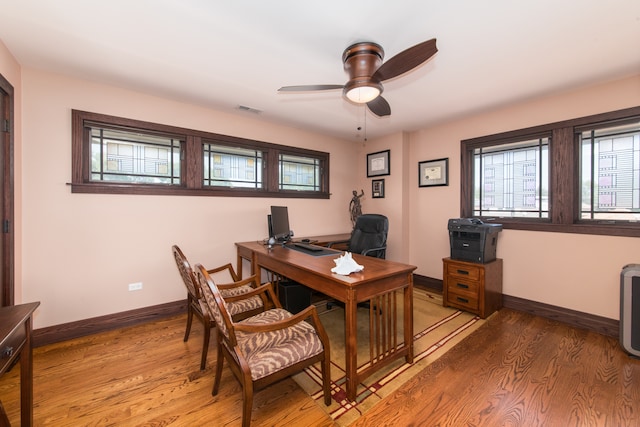 office space with light hardwood / wood-style flooring and ceiling fan