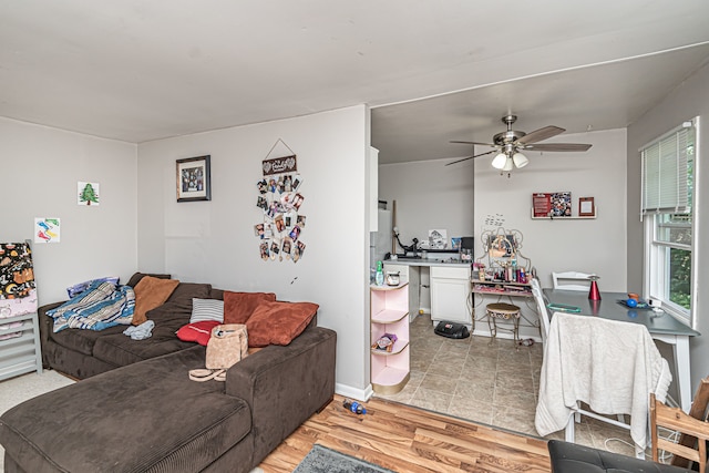 living room with ceiling fan and light hardwood / wood-style flooring