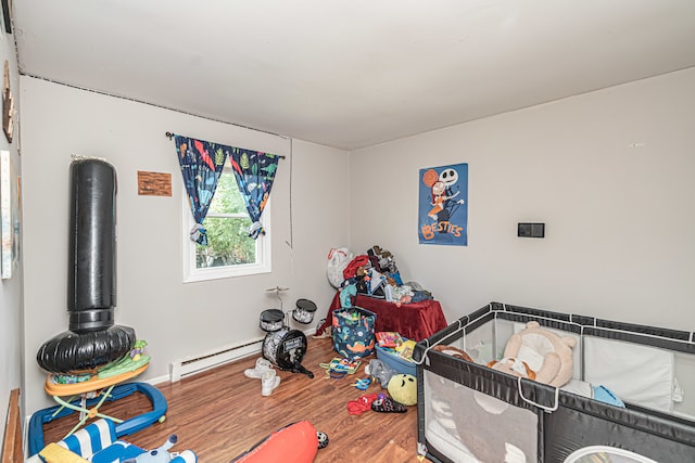 rec room featuring wood-type flooring and baseboard heating