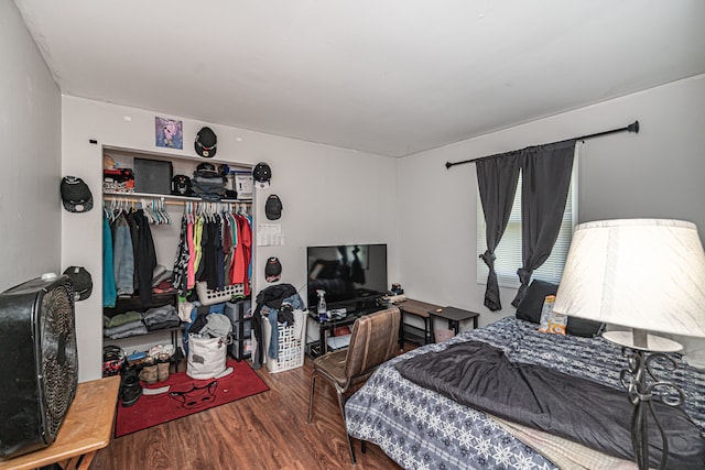 bedroom featuring wood-type flooring and a closet