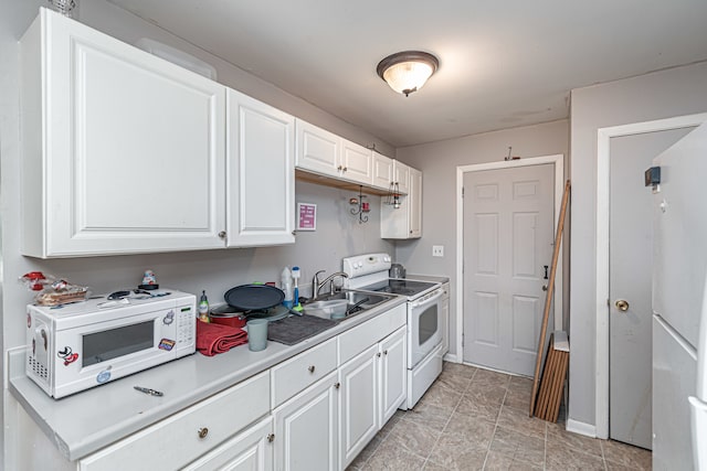 kitchen featuring light tile patterned floors, white appliances, sink, and white cabinetry