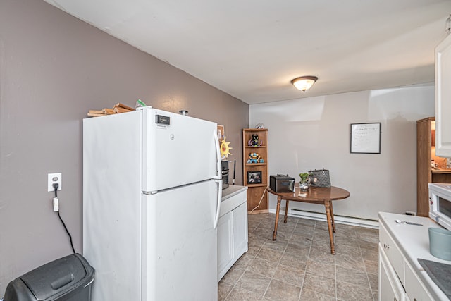 kitchen featuring white cabinets, white refrigerator, light tile patterned flooring, and a baseboard radiator