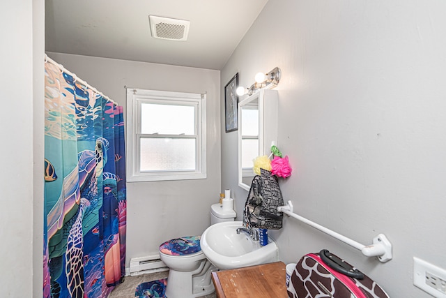 bathroom featuring a baseboard radiator, toilet, and sink