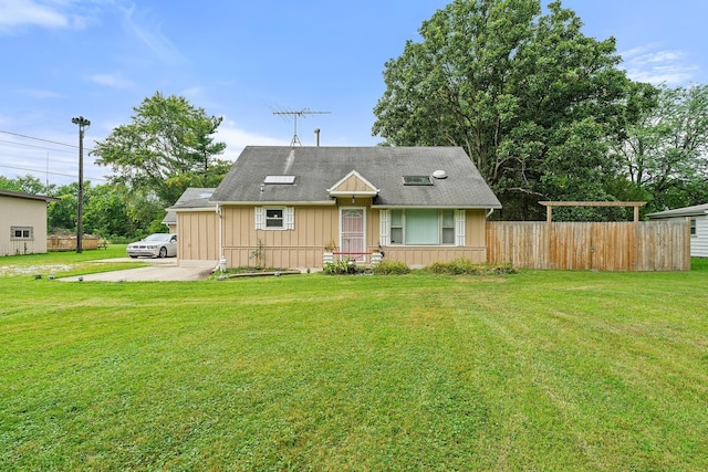 view of front of property featuring a front yard, fence, and board and batten siding