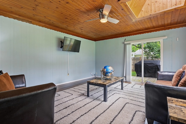 living room with a skylight, wooden ceiling, ceiling fan, and light wood-type flooring