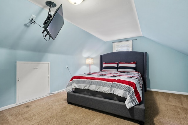 bedroom with carpet floors and lofted ceiling