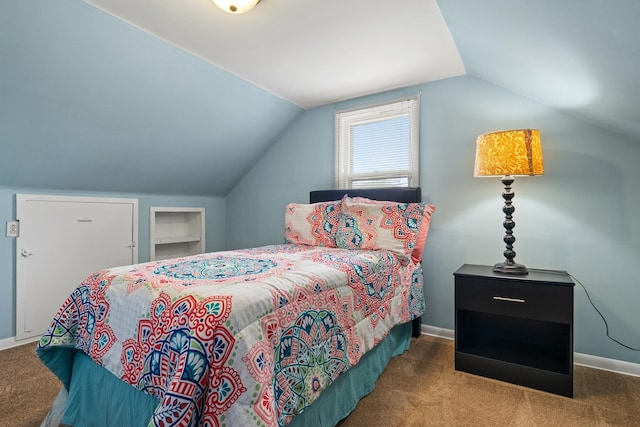 bedroom with lofted ceiling and carpet floors