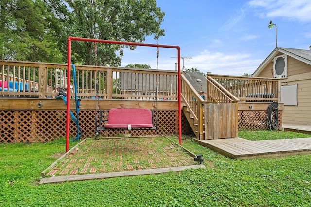 view of jungle gym featuring a yard and a wooden deck