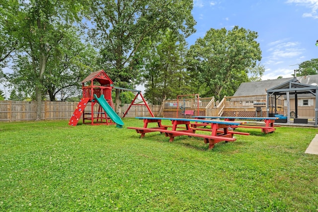 view of jungle gym featuring a lawn and a gazebo