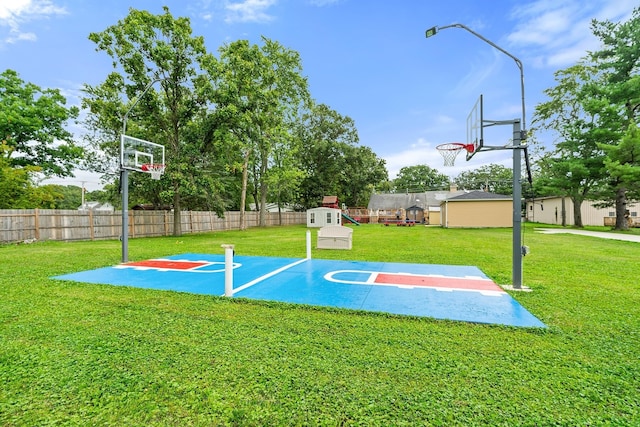 view of basketball court with a yard and a playground