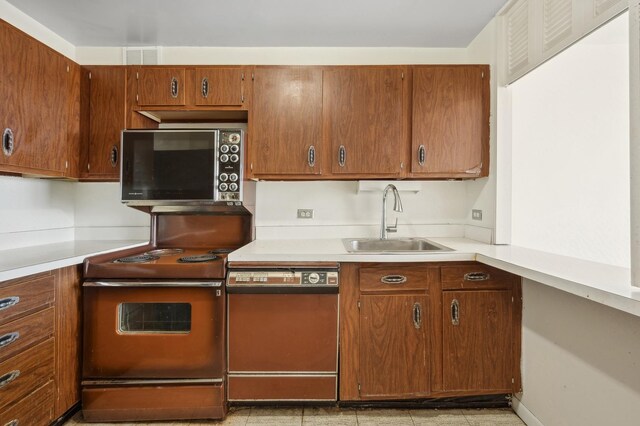 kitchen featuring a sink, electric stove, light countertops, and dishwasher