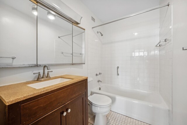 full bath featuring tub / shower combination, tile patterned floors, toilet, and vanity