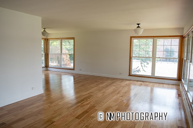 unfurnished room with hardwood / wood-style floors and a healthy amount of sunlight