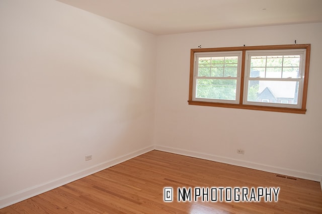 empty room with light hardwood / wood-style flooring