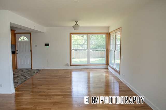 unfurnished living room with hardwood / wood-style flooring and a wealth of natural light