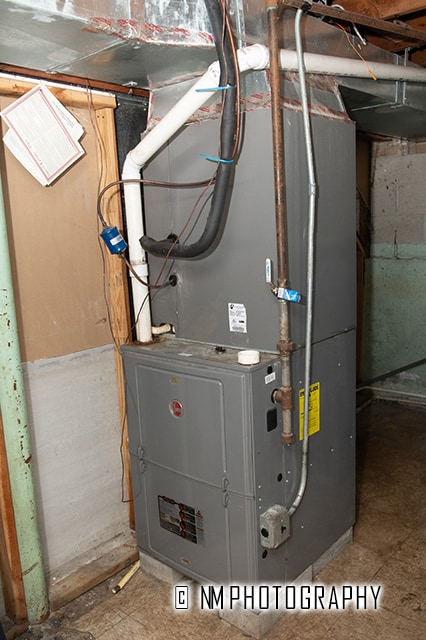 utility room featuring heating unit