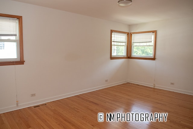 spare room featuring light wood-type flooring