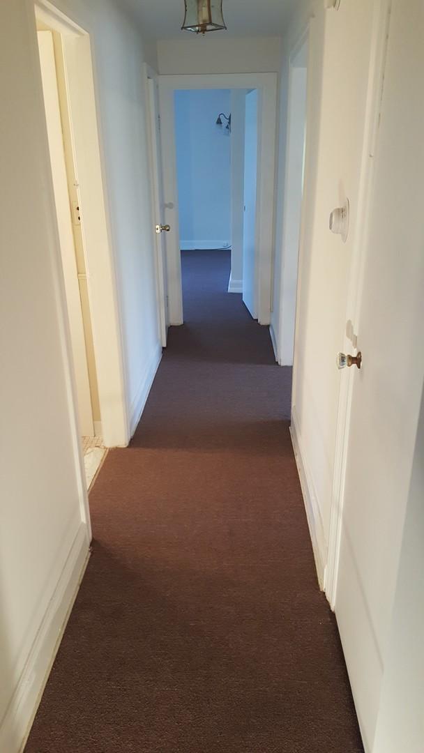 corridor with dark colored carpet