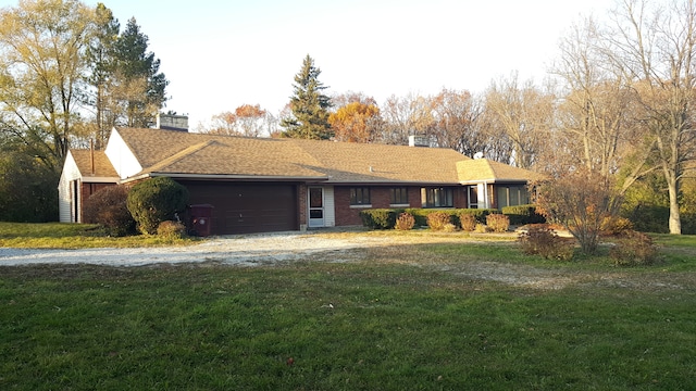 ranch-style house featuring a garage and a front yard