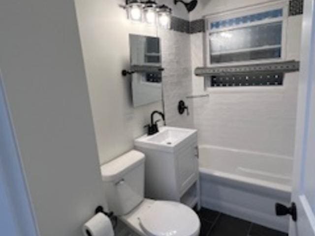 full bathroom with vanity, toilet, tiled shower / bath combo, and tile patterned flooring