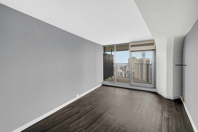 unfurnished room featuring dark hardwood / wood-style flooring