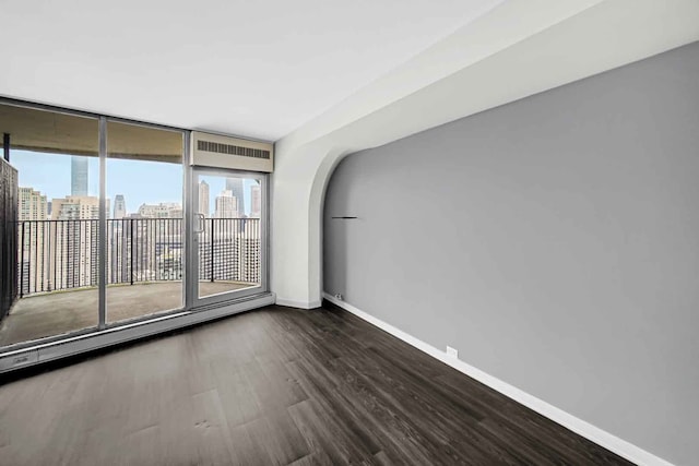 spare room featuring wood-type flooring