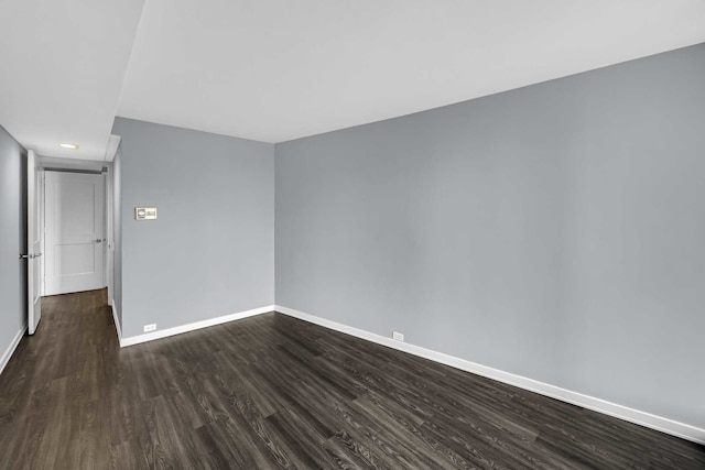 spare room featuring dark wood-type flooring