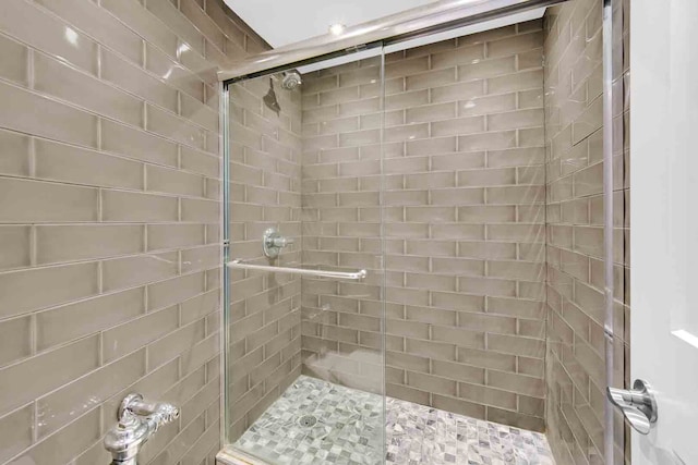 bathroom featuring a shower with door