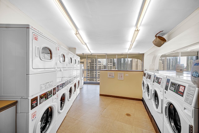 laundry area with light tile patterned flooring, washer and dryer, and stacked washing maching and dryer