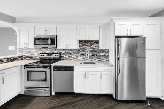 kitchen featuring dark wood-type flooring, white cabinets, sink, and stainless steel appliances