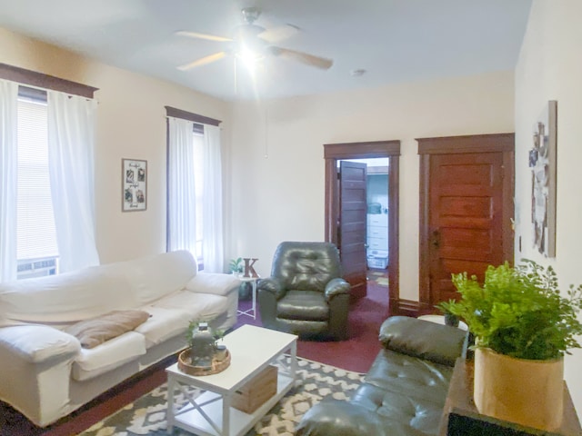 carpeted living room with ceiling fan