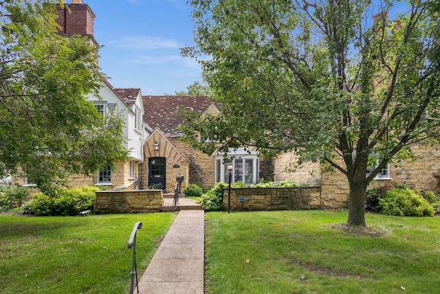 tudor home with a front yard