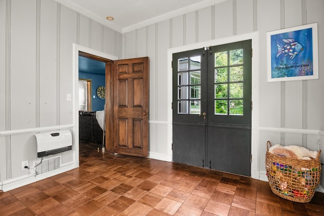 foyer entrance featuring ornamental molding and french doors