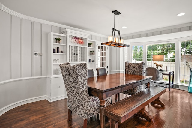 dining room with built in features and dark wood-type flooring