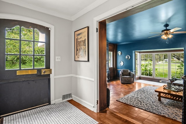 doorway featuring crown molding and ceiling fan