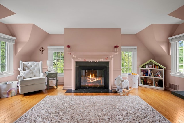 interior space with lofted ceiling and hardwood / wood-style floors