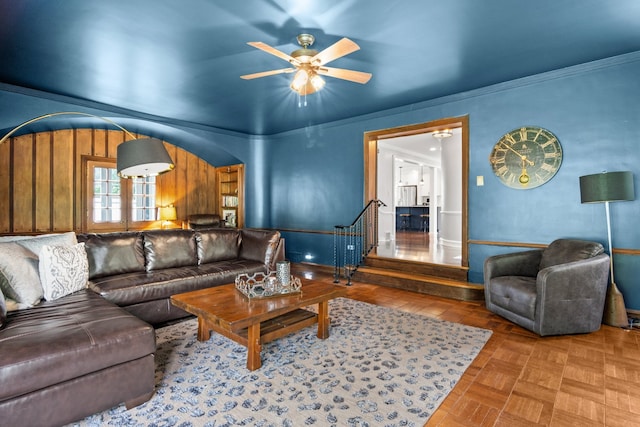 living room featuring ceiling fan, parquet flooring, and ornamental molding