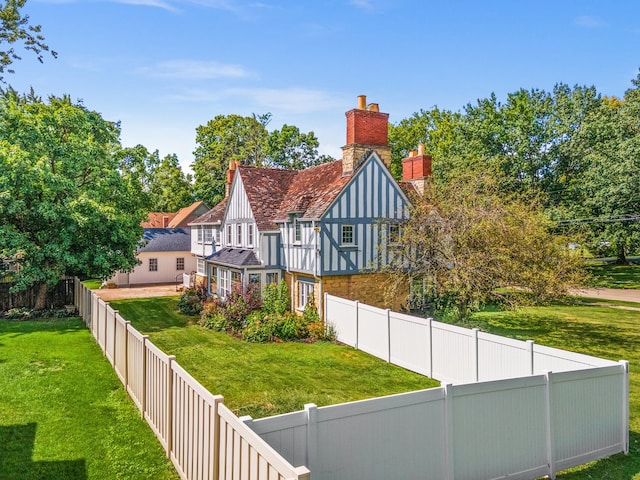 rear view of property featuring a lawn