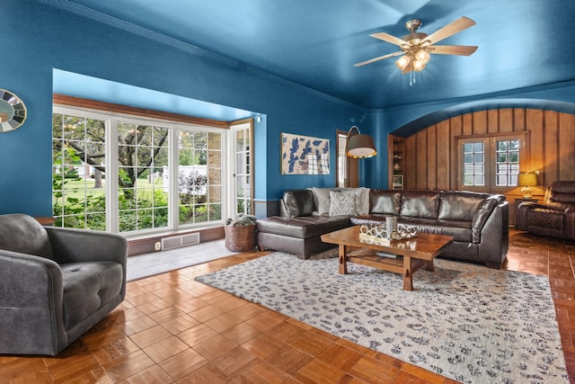 living room with ceiling fan and crown molding